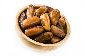 Dates food in wooden bowl isolated on white background
