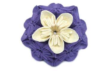 Fototapeta na wymiar Purple and white origami kusudama flower on white background