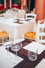 Table setting in restourant terrace. Wine glass, tablecloth