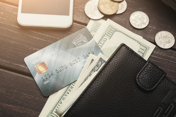 Banknotes in wallet with coins and credit card