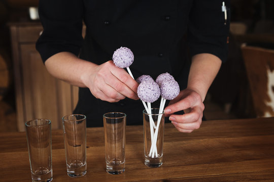 Pink cakepops in glasses, closeup