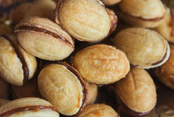 Cookies in shape of nut with condensed milk, closeup
