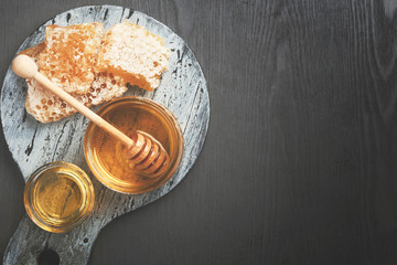 Honey background. Honey with wooden honey dipper on wooden table