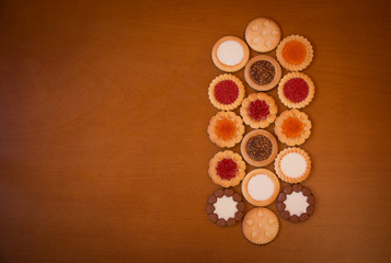 Assortment of mixed cookies on rustic wooden background with copy space. Top view.