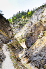 Hikers at gorge Aschauklamm, Bavaria in spring time, early morning