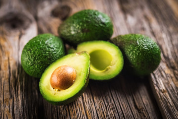 Avocados on wooden background - 205096327