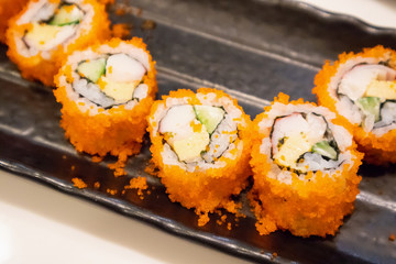 California maki sushi roll on black plate, japanese food