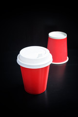 Red coffee cup on black background. Coffee to go