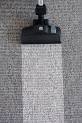 housekeeping before and after concept - modern vacuum cleaner on carpet floor