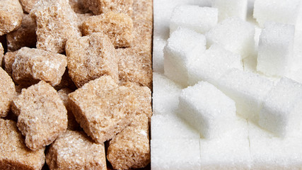 Heap white and brown cane unrefined sugar cubes