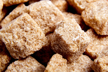 Heap brown cane unrefined sugar cubes