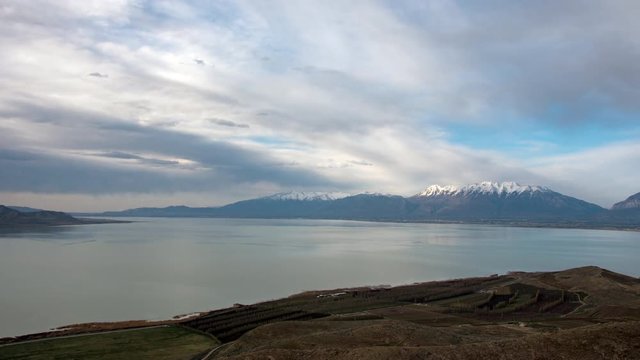 Time lapse looking over Utah Lake towards Provo and Mount Timpanogos on a cloudy day from West Mountain.