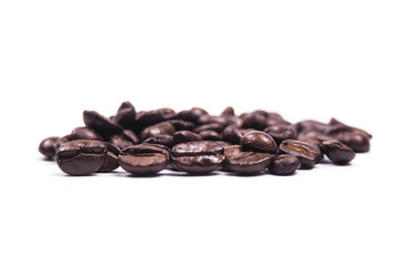 Cup of coffee and coffee beans on wooden spoon on white background