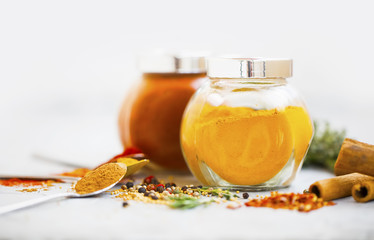 Aromatic spices in jars. Turmeric powder in a jar