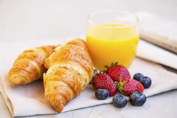 Healthy breakfast with croissants , orange juice and berries