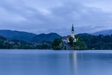 Fototapeta na wymiar Amazing View On Bled Lake, Island,Church With Mountain Range (Stol, Vrtaca, Begunjscica). Bled,Slovenia,Europe 