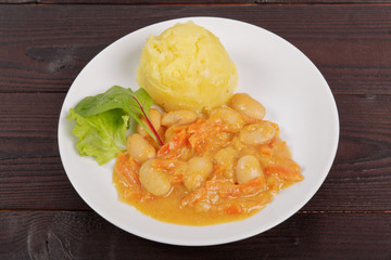 Beans with carrots and potatoes on a table