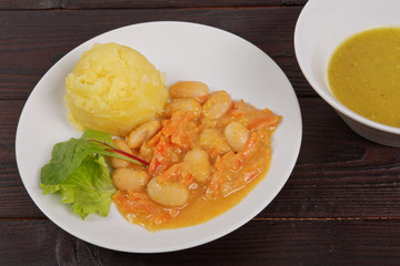 Beans with carrots and potatoes on a table