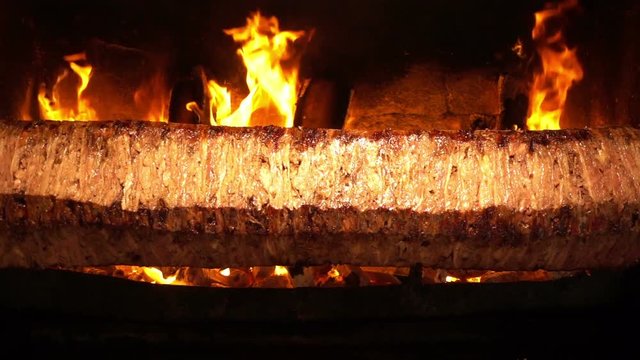 Turkish Anatolian Traditional Eastern Food Beef or Lamb Doner Kebab / Delicious Meat Food, in restaurant they cut the cooked part slicely and add it on pide and served with youghurt and tomato paste 