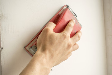 Sanding of walls, plastering works, hand