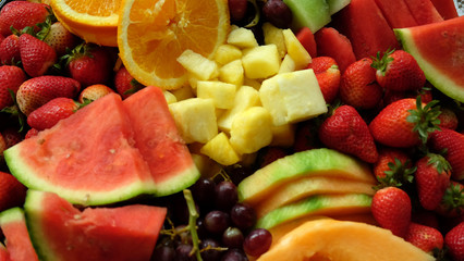 fruit platter with orange watermelon pineapple strawberries grapes