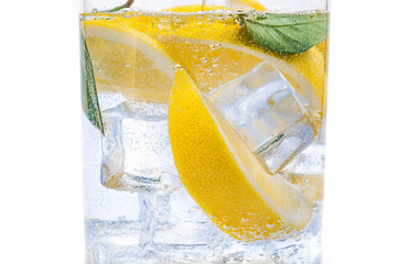 In the jug is a drink of ice, the lobules of a fresh juicy lemon and crystal clear water.