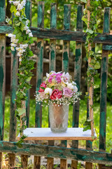 Fototapeta na wymiar Wedding bouquet of artificial flowers on swing. Marriage concept