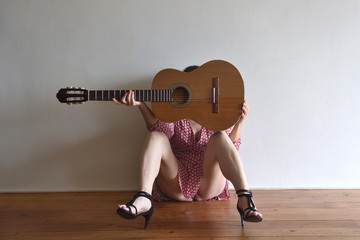 woman with a guitar on her face