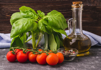 Cooking ingredients - basil leaves, tomato, olive oil