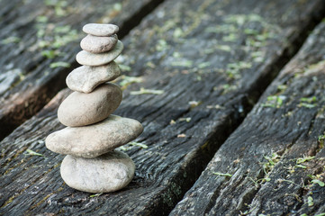 closeup of stone balance on wooden table  background