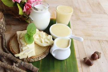 Dip cheese with milk on wood background