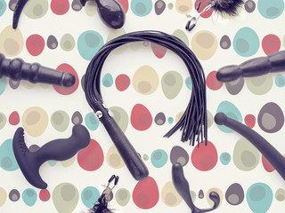 Toys for adults are on a colorful abstract background. The image is suitable for advertising a sex...