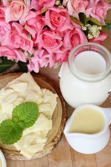 Dip cheese with milk on wood background