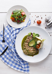 Appetizing grilled beefsteak and healthy vegetable salad