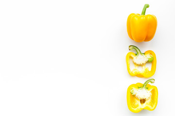 Layout of yellow sweet bell pepper slices on white background top view copy space