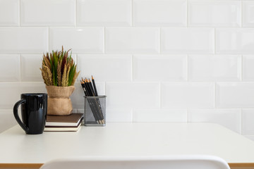 White desk table with copy space, supplies and coffee mug. Front view workspace and copy space