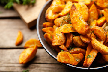 Baked potato fries on wooden table