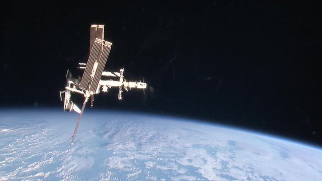 International Space Station above Earth, zoom in