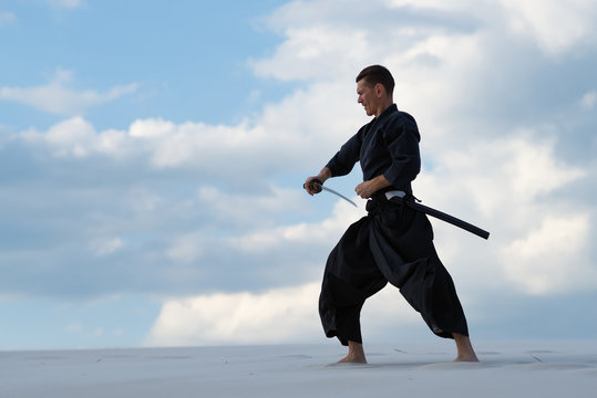Focused man is practicing Japanese martial art