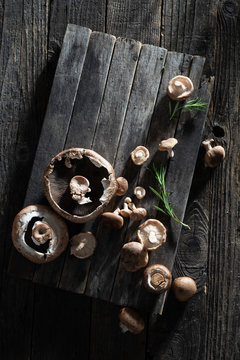 Raw Mushrooms with Fresh Herbs on a Rustic Farmhouse Table