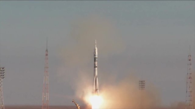 Rocket launches in remote desert, tilt up