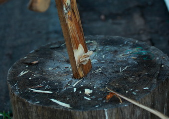 Man chopping wood. Cut from the ax on the Board.