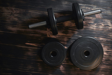 Dumbbells on a dark wooden background. Concept CrossFit