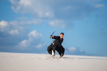 Man jumps with a Japanese sword, katana