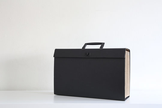 Black documents foder in a white background, negative space