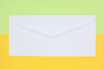 white envelope mail on yellow and green background