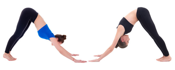 two young women standing in yoga pose isolated on white