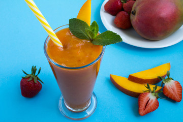 Smoothie  from  mango and strawberry  on the  blue background