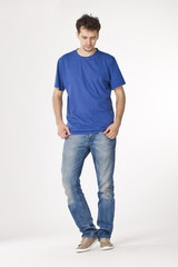 Young man in blue T-shirt standing and looking down