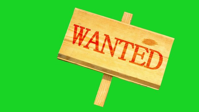 wooden sign with an inscription of wanted oscillates from side to side against the background of the green chroma key